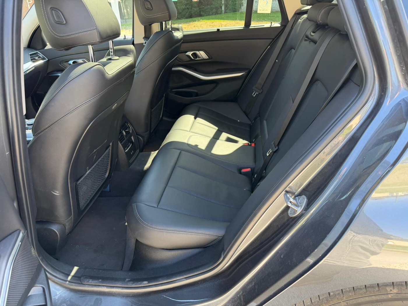 Intérieur arrière BMW 320e — banquette cuir pour trajets confortables